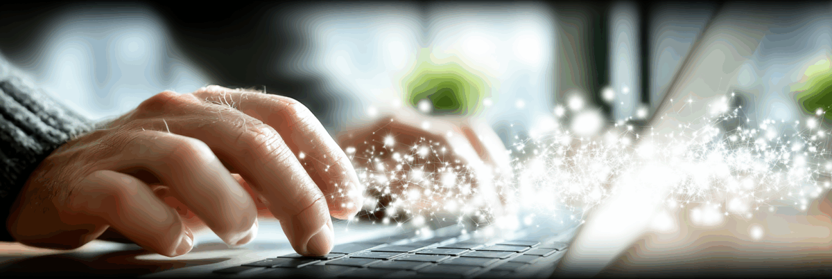 Close-up of hands typing on a laptop keyboard, with glowing sparks and digital light patterns emerging, symbolizing online connection and trust in digital spaces.