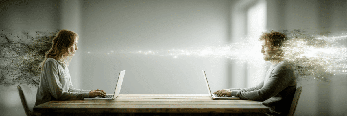 Two people sit facing each other at a wooden table, each on a laptop. A glowing stream of light and energy connects them across the space, symbolizing digital trust and communication.