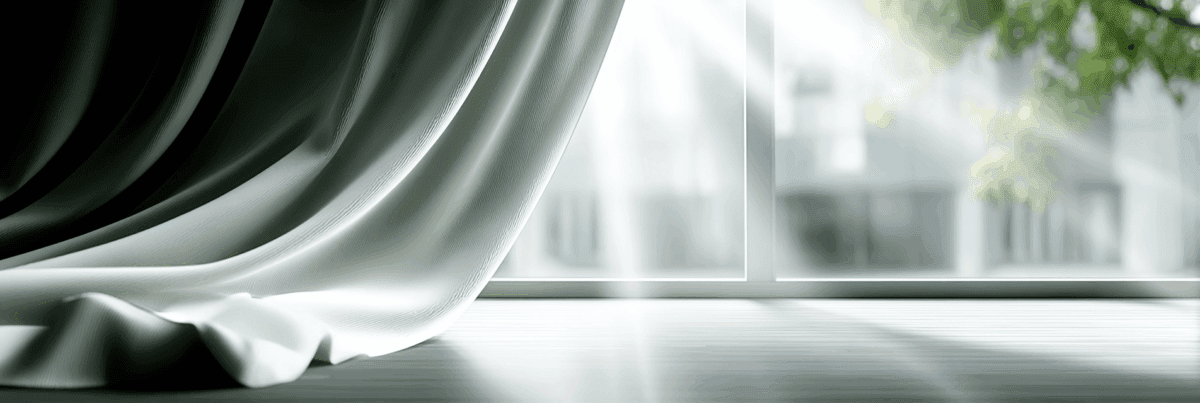 Soft morning light filters through flowing curtains, casting gentle shadows on the floor and creating a calm sense of renewal.
